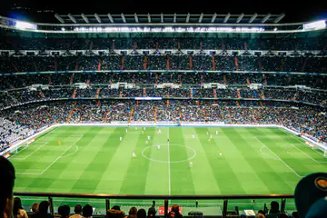 Night football match in a packed stadium